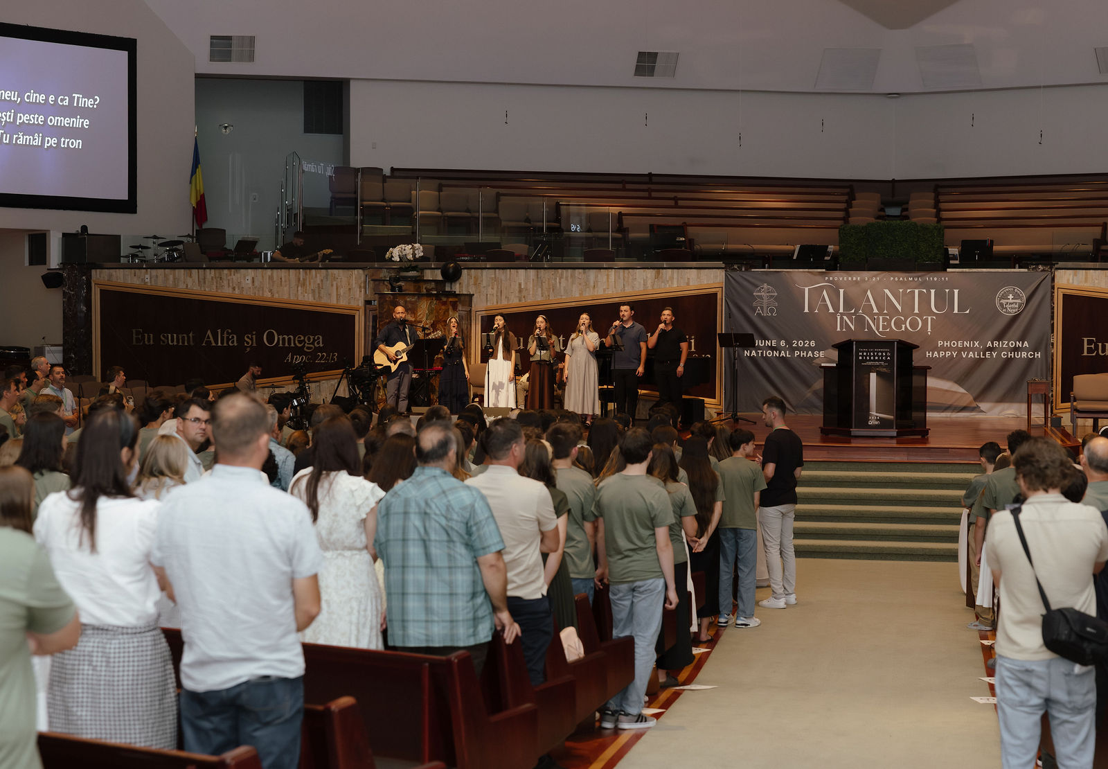 Congregation standing as the worship team leads at the 2026 National Phase